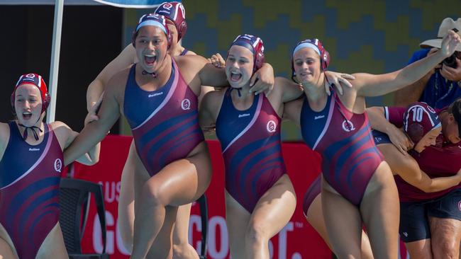 Annabel Cowan, left, Taafili Taoso, Olivia Muir, far right, and Queensland teammates enjoy a victory earlier this year. Picture: Jerad Williams