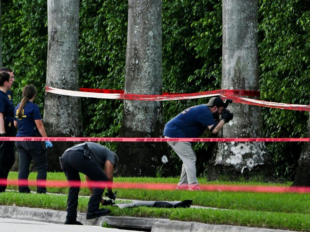 FBI agents at the crime scene. Picture: Chandan Khanna/AFP