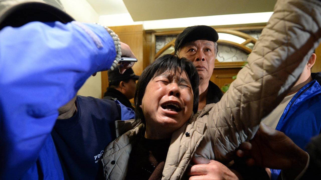 A relative of passengers on Malaysia Airlines flight MH370 cries after hearing the news that the plane plunged into Indian Ocean. Picture: Goh ChaiI Hin/AFP