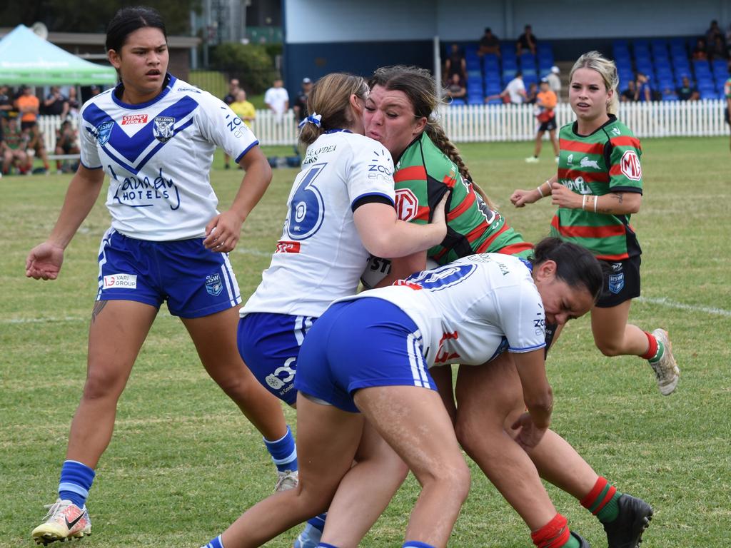 Mackenzie Schoultz is tackled by Abby Aros (left) and Teora Dennis. Picture: Sean Teuma