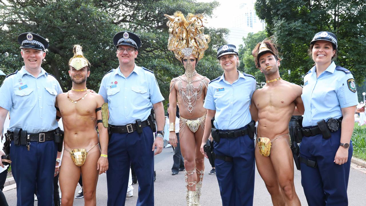 Bruno Almeida, Joshua Heath, Daniel Franklin with NSW police before the start of the Sydney Gay and Lesbian Mardi Gras Parade. Picture: Damian Shaw