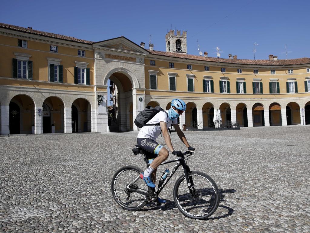 Italian professional cyclist Davide Martinelli rides his bike after collecting medicine at a pharmacy in northern Italy. Picture: AP