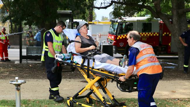 Paramedics move a patient from the scene. Picture: Dylan Robinson