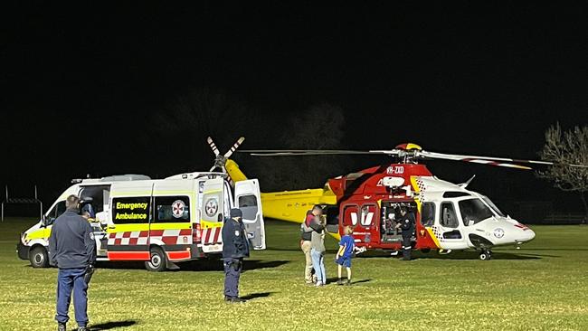 Police officers watch on as paramedics prepare to transfer a 7-year-old boy into a Westpac Rescue Helicopter in Connell Park, Bellingen. The boy suffered head and chest injuries after a motorcycle accident just before 5pm on Monday July 26.