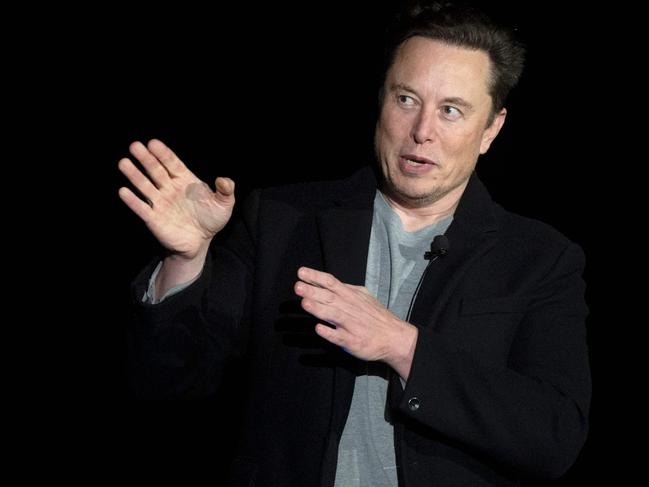 (FILES) In this file photo taken on February 10, 2022 Elon Musk gestures as he speaks during a press conference at SpaceX's Starbase facility near Boca Chica Village in South Texas. - The Twitter accounts of several journalists suspended after Musk accused them of endangering his family were reinstated on December 17, 2022, but some said the billionaire owner offered full use of the platform only if they deleted posts about tracking his location. Musk had drawn anger and warnings from the EU and UN after suspending the accounts of more than a half-dozen prominent journalists from The New York Times, CNN, The Washington Post and other outlets. (Photo by JIM WATSON / AFP)