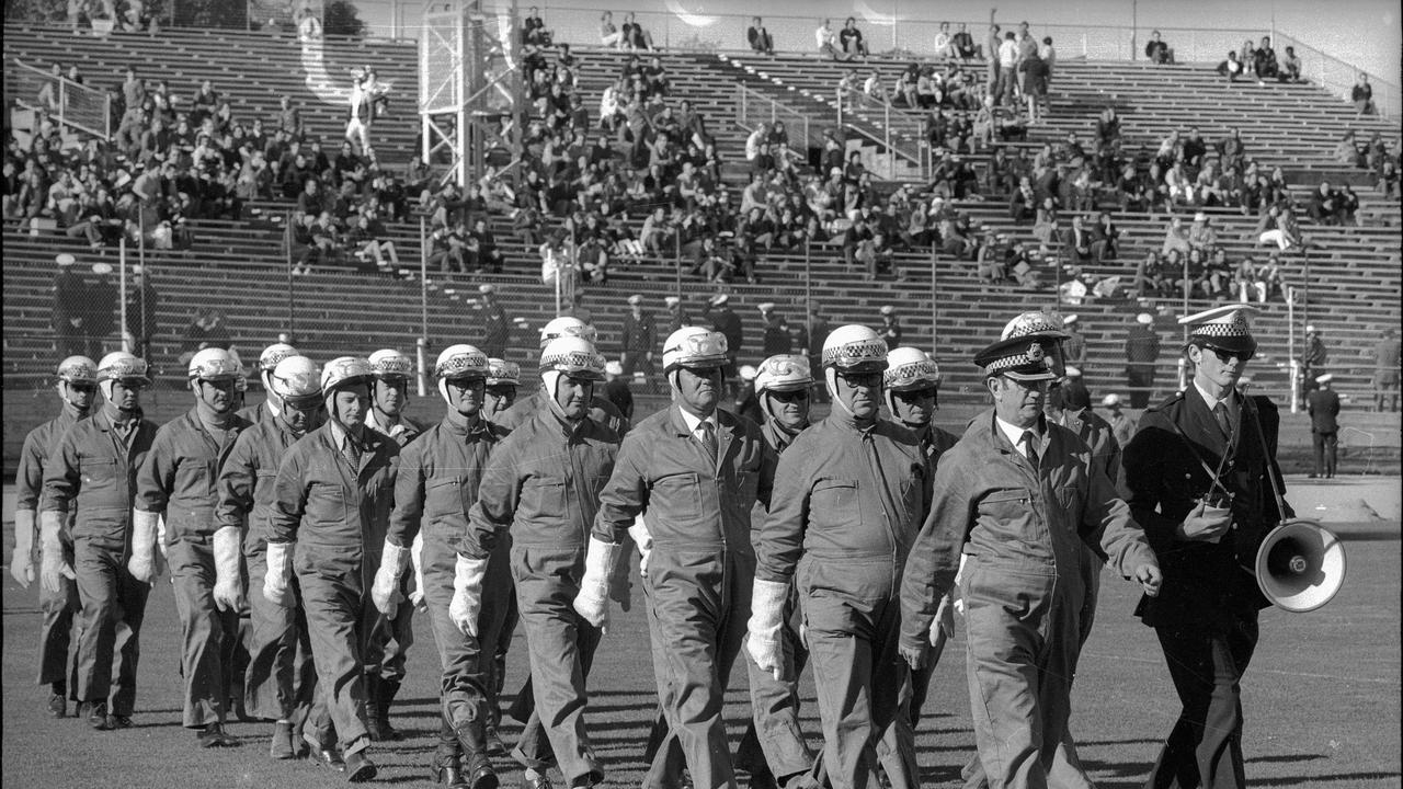 Chief of the CIB Technical section, Inspector Les Bardwell (front right) leads the bomb squad on to the Brisbane Exhibition Ground before the start of the Springbok vs Qld rugby match in 1971. Picture: Bob Barnes