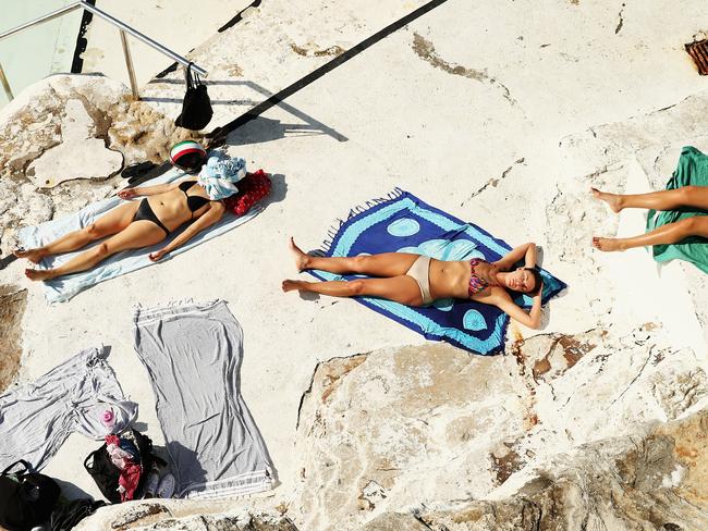 Sunbakers at Bondi Beach on Friday. Picture: Ryan Pierse/Getty Images