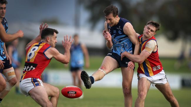 Glenunga’s Harry Prosser under pressure from Old Ignations’ Hugh Ferrari and William Abbott (no. 8). Picture Dean Martin