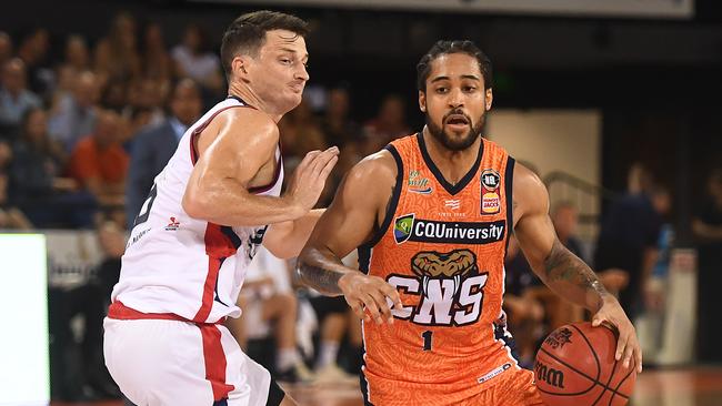 Melo Trimble of the Taipans drives past Shaun Bruce of the 36ers