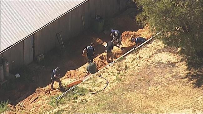 Police dig for evidence at the property. Picture: 7 News Adelaide