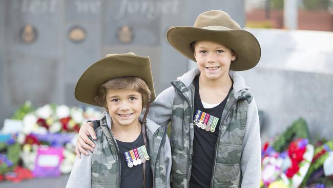 Jesse O'Brien, 6, and Kai O'Brien, 7, of Prestons, NSW wearing their grandfather’s Vietnam miniatures during the Anzac Day service at Liverpool this morning. Picture: Melvyn Knipe