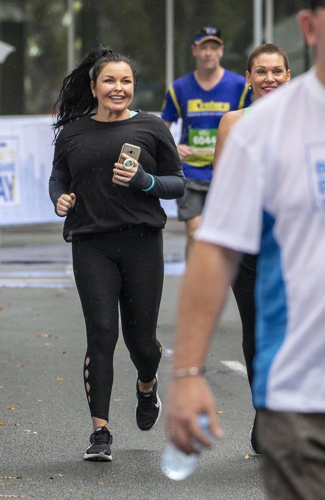 Corby crosses the finish line in the Sunday Mail Bridge to Brisbane Fun Run in 2018. Picture: AAP