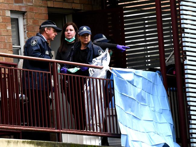 AFP officers on a balcony of the Ascot Vale flats. Picture: Nicole Garmston