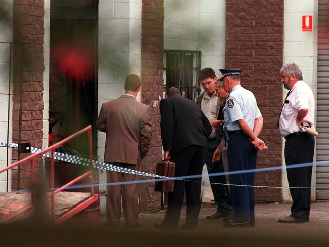 September 22, 1999: Police search for evidence at a Rebels clubhouse in Yandina Road, West Gosford, where man was killed.