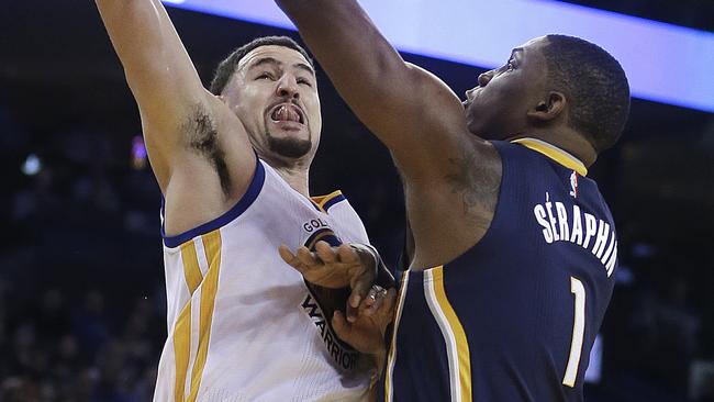 Klay Thompson, left, makes a shot against Indiana Pacers' Kevin Seraphin.