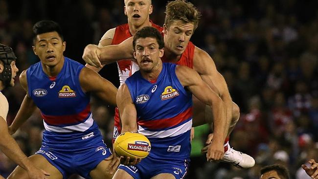 Tom Liberatore is tackled by Luke Parker in Round 2. Picture: Wayne Ludbey