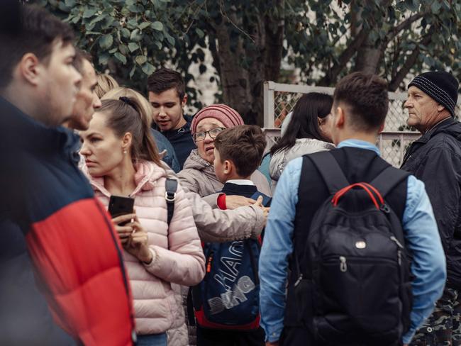 A woman hugs a boy surrounded by other people near the scene of a shooting in school No88 in Izhevsk. Picture: Kommersant Photo / AFP