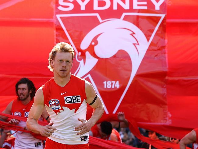 MELBOURNE, AUSTRALIA - SEPTEMBER 24: Callum Mills of the Swans leads his team out through the banner during the 2022 AFL Grand Final match between the Geelong Cats and the Sydney Swans at the Melbourne Cricket Ground on September 24, 2022 in Melbourne, Australia. (Photo by Mark Kolbe/AFL Photos/via Getty Images)