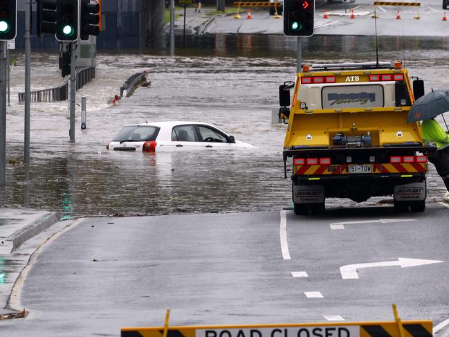 A car is stuck in flood waters in Toombul after heavy rain fell overnight in Brisbane. Picture: Tertius Pickard