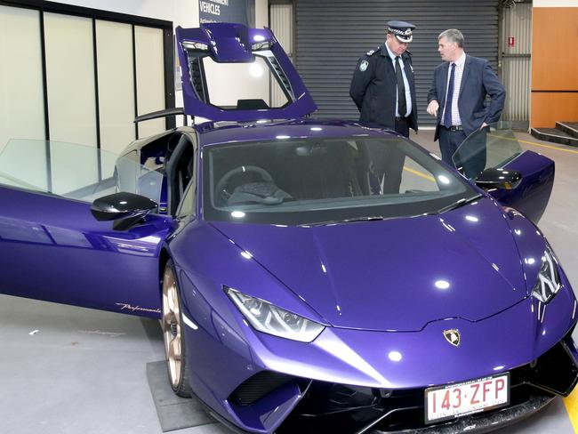 The Lamborghini is now up for auction by police. Police Minister Mark Ryan (right) and Acting Assistant Commissioner Ray Rohweder inspect the vehicle. Picture: Steve Pohlner