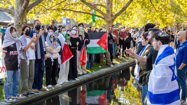 Israel and pro-Palestinian demonstrators face off in a park near Melbourne University. Picture: Jason Edwards