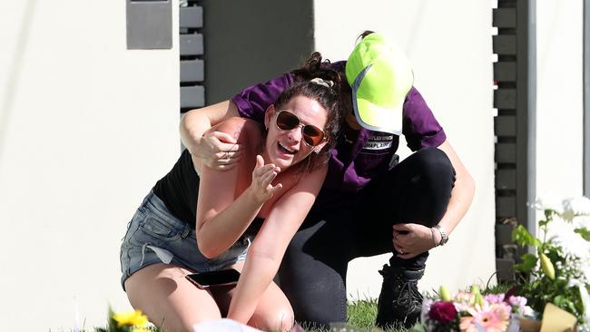 A woman becomes overwhelmed as she visits the memorial site. Picture: Liam Kidston