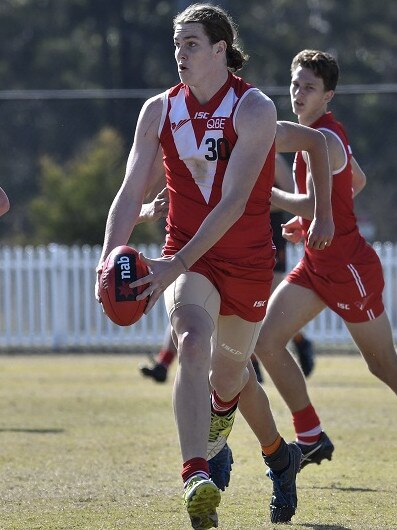 Ellem runs the ball for the Sydney Swans Academy.