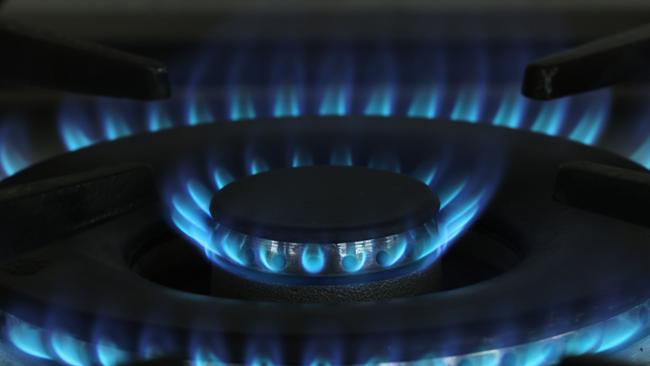 A gas flame burns on a gas stove top. Picture: Sean Gallup