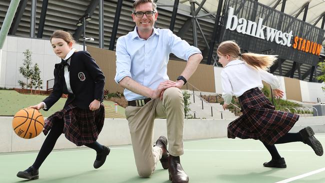 NSW Treasurer Dominic Perrottet playing basketball with his daughters Charlotte, 9, and Amelia, 7, outside Bankwest Stadium, Parramatta. Picture: Brett Costello