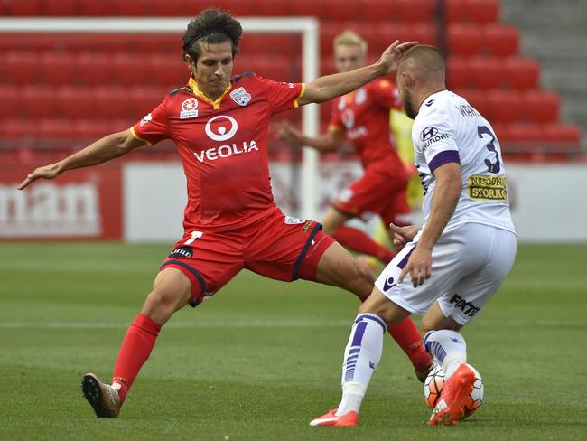 Pablo Sanchez of Adelaide United competes for possession with Marc Warren of Perth Glory.
