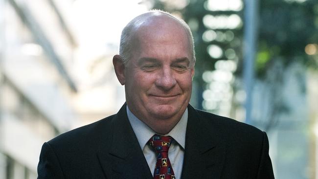 Former Queensland Government minister Gordon Nuttall smiles as he arrives at the District Court in Brisbane in 2009. (AAP Image/Dave Hunt)