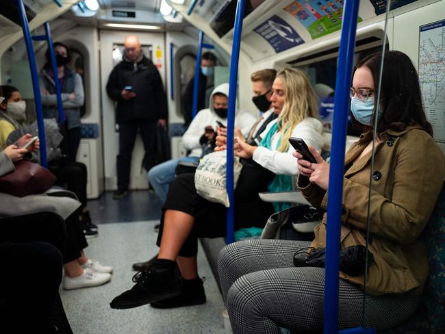 Commuters, most wearing masks because of the coronavirus pandemic, travel on a London Underground tube train in central London. Picture: AFP