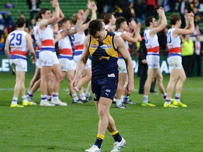 West Coast's Luke Shuey leaves the field as the Bulldogs celebrate their shock elimination final win. Picture: Daniel Wilkins