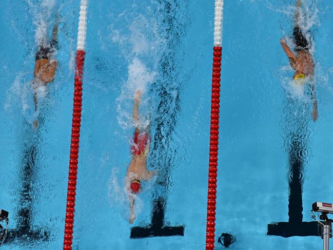 China's Pan Zhanle (C) record breaking men's 100m freestyle in Paris. Picture: Manan VATSYAYANA / AFP