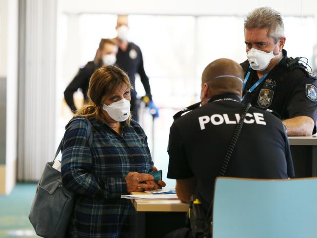 A passenger who flew with Jetstar to Sunshine Coast airport from Melbourne goes through questioning with Queensland Police on arrival. Photo Lachie Millard