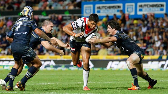 Rooster Latrell Mitchell is tackled during a Cowboys clash.