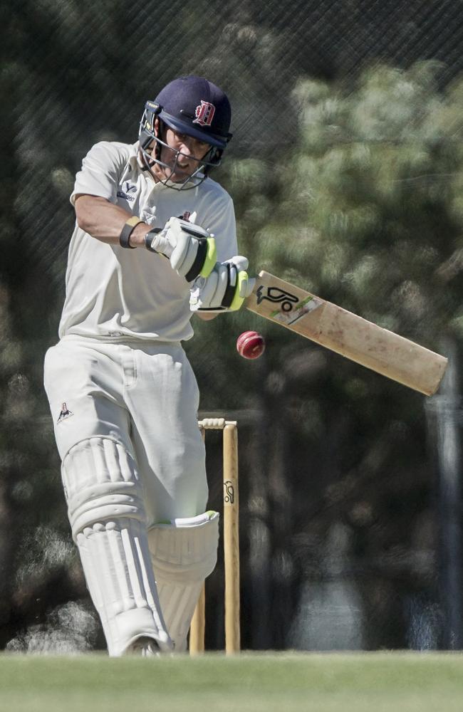 Dandenong captain Tom Donnell deals with a short ball.