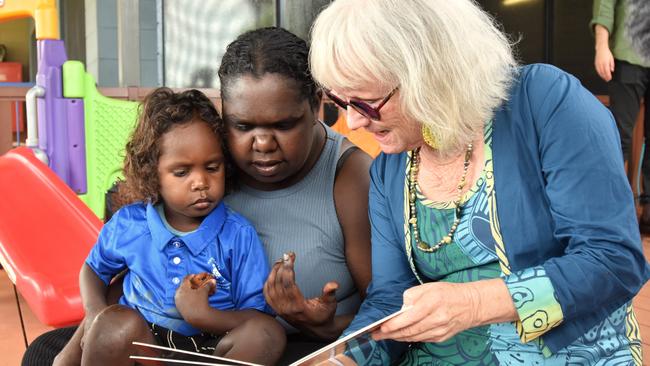 Gunbalanya School's first Families as First Teachers Educator Nuala Scannell works through conversational reading exercises with a parent and child as part of the FAFT program. Picture: Sierra Haigh