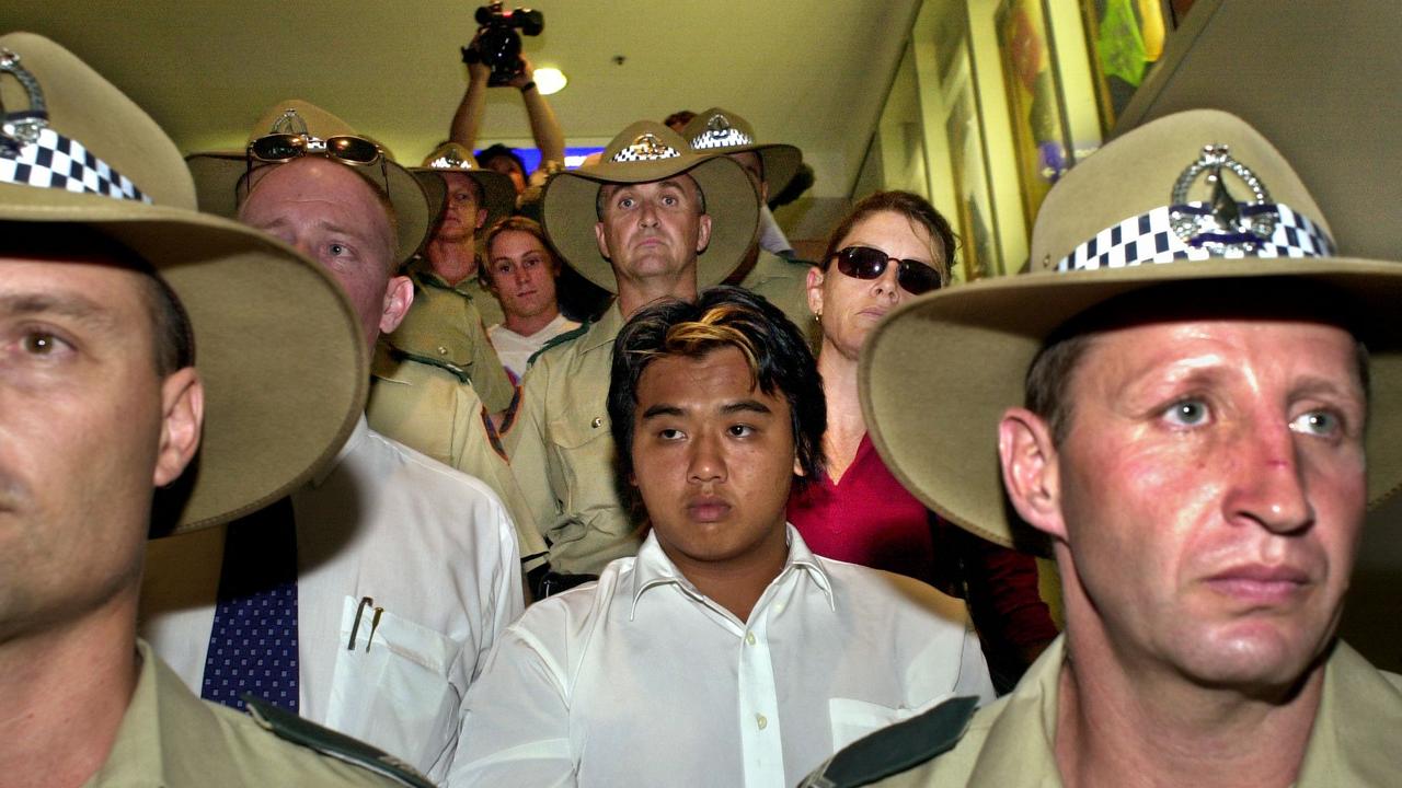 Prostitute Murder Suspects – Phu Ngoc Trinh and Ben William McLean escorted by Police and Detectives through Darwin Airport – Picture: MICHAEL MARSCHALL