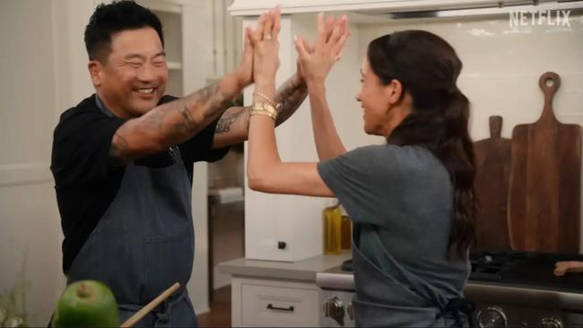 Meghan high-fives a guest chef...