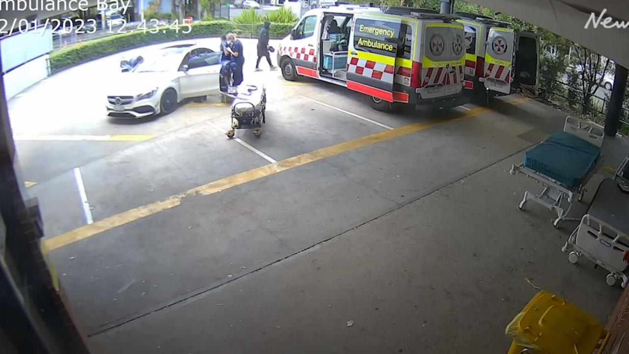 The man walks away as paramedics tend to the woman. Picture: Supplied