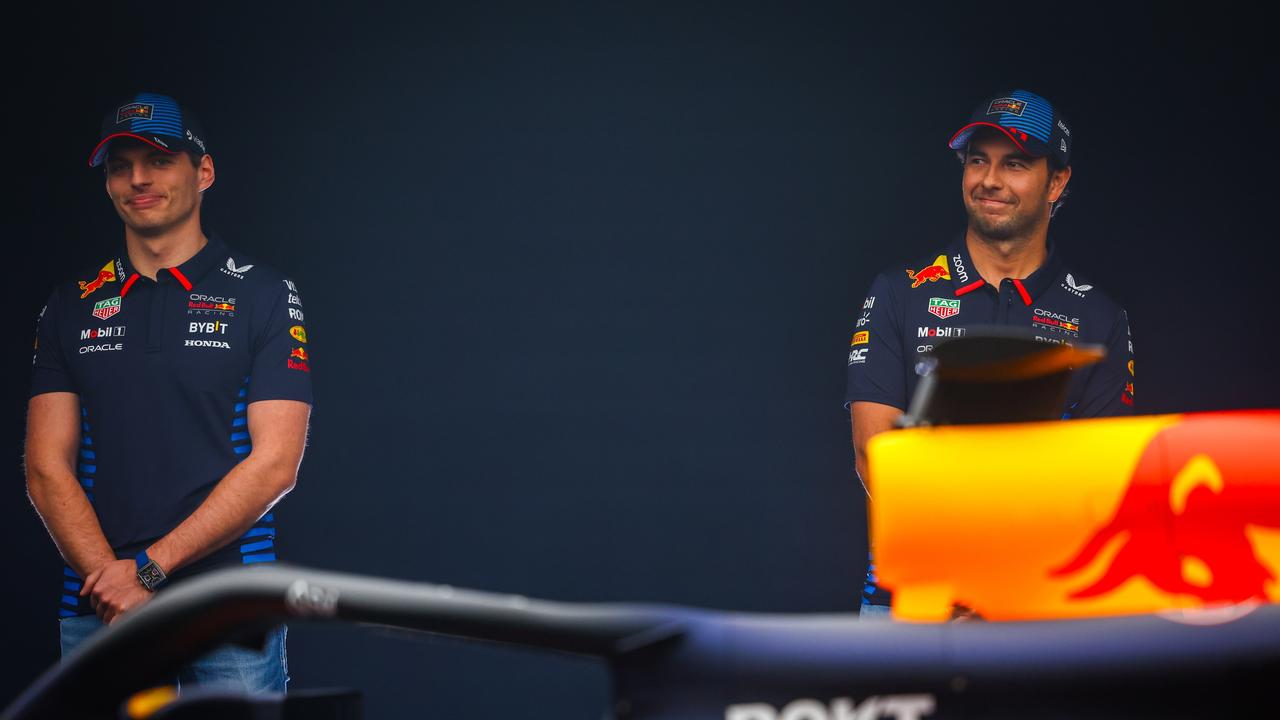 Max Verstappen and Sergio Perez in front of the bold new RB20.