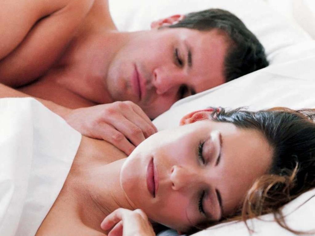 Couple sleeping in bed on Sealy Posturepedic mattress. model male generic sleep