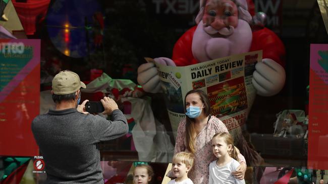 A family post for a picture outside a Christmas display in the Melbourne CBD, Victoria. Picture: NCA NewsWire / Daniel Pockett