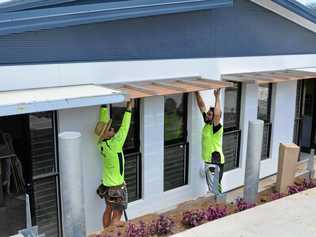 FINISHING TOUCH: Carpenters Izac Browning and Gavin Mead work hard for Gatton's Rooms Hotel to open next week. Picture: Francis Witsenhuysen