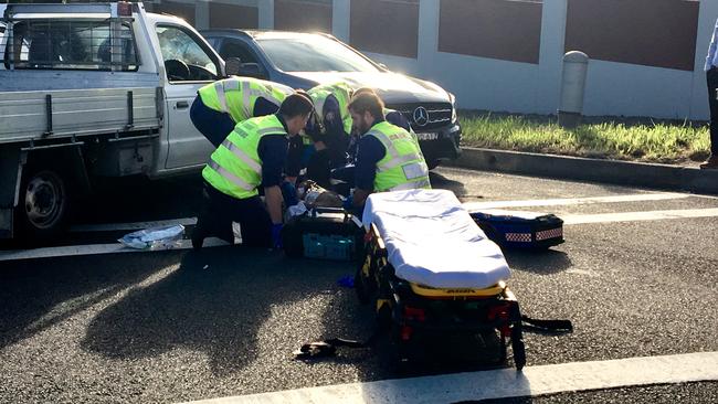 Paramedics stabilise a man after he was revived after an accident in Baulkham Hills.