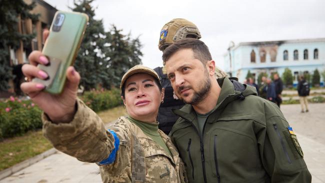 Ukrainian president Volodymyr Zelensky poses with a servicewoman in the de-occupied city of Izyum, Kharkiv region. Picture: AFP