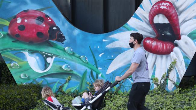 A man walks his kids at Southbank in Melbourne. Picture: David Crosling