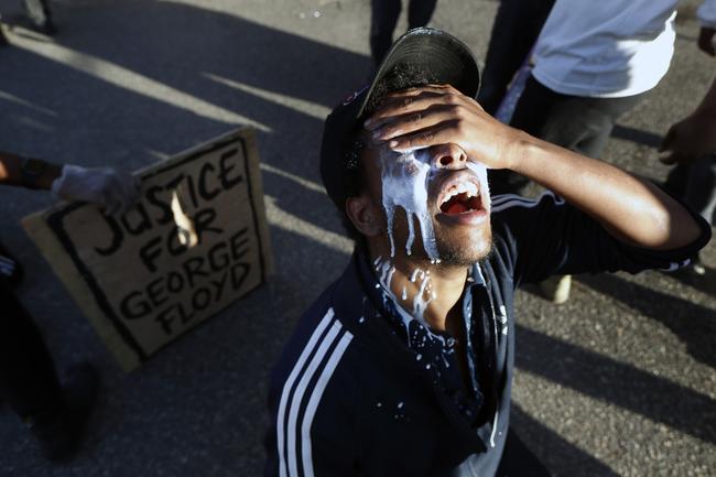 A protester is doused with milk in Minneapolis. Picture: AP