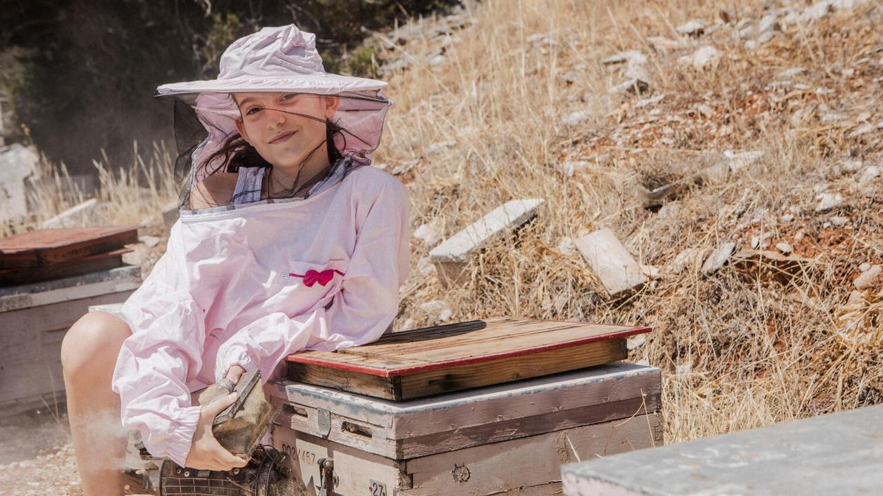 Eleven-year-old Markela is meant to one day take over her grandfather’s beekeeping business in Greece, but wildfires have put their future in doubt. Picture: UNICEF/Anna Pantelia